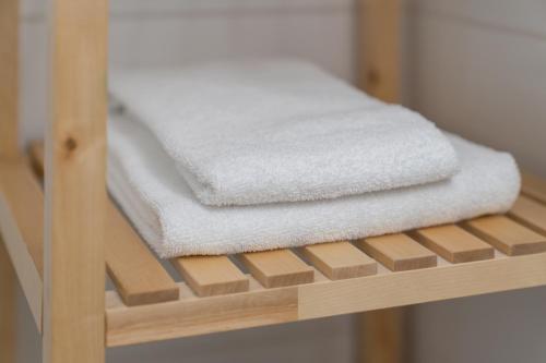 a pile of towels sitting on a wooden shelf at Appartement De Jutter, Resort Amelander Kaap in Hollum