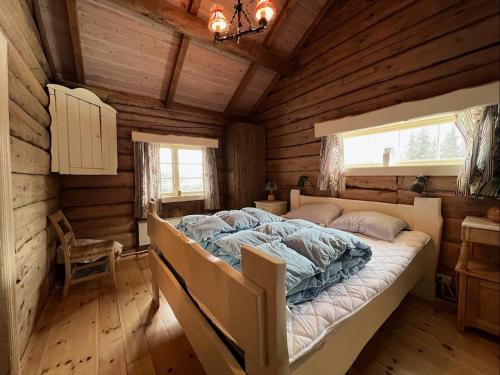 a bedroom with a bed in a log cabin at Idyllisk feriested in Gol
