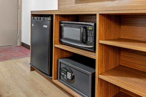 a kitchen with a microwave and a refrigerator at Red Roof Inn PLUS+ Columbus-Ohio State University OSU in Columbus