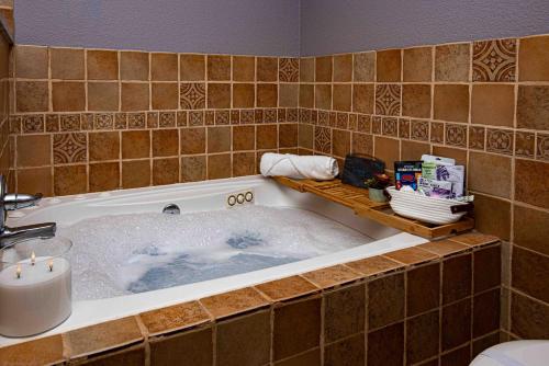 a bathroom with a bath tub filled with water at InHomeStays in Lakewood
