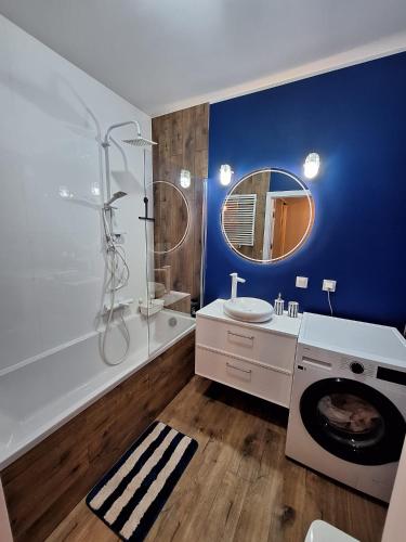a bathroom with a shower and a sink and a washing machine at U Rudobrodego in Pogórze