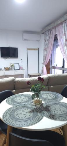 a living room with a table and a couch at Moradia Belo horizonte in Alfena