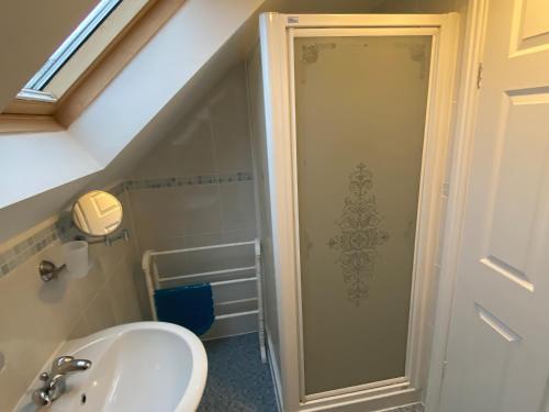 a bathroom with a sink and a shower at The Old Cider Barn in Wells