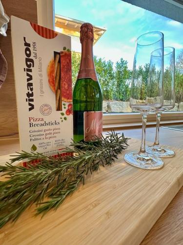 a bottle of wine and two glasses on a table at Autumn Apartment in Gerbrunn