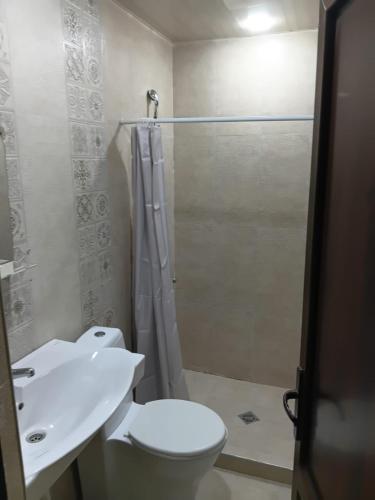 a bathroom with a toilet and a sink and a shower at Villa Gast Haus in Tsaghkadzor