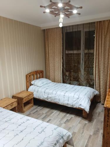 a bedroom with two beds and a ceiling at Villa Gast Haus in Tsaghkadzor