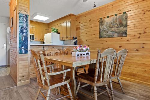 a kitchen with a wooden table and chairs at Bear Cub Retreat in Gatlinburg