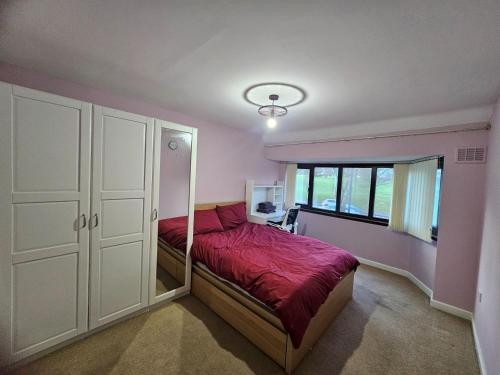 a bedroom with a bed and a large window at Little puppy in Birmingham