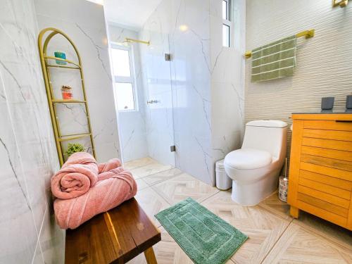 a bathroom with a toilet and a towel on a table at Blue House near Tolantongo Caves in San Miguel