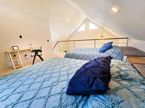 a bedroom with two beds with blue comforter at Blue House near Tolantongo Caves in San Miguel