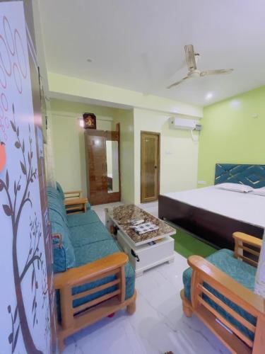 a bedroom with a bed and two couches in it at The Cruze - Premium Hotel in Gulzārbāgh
