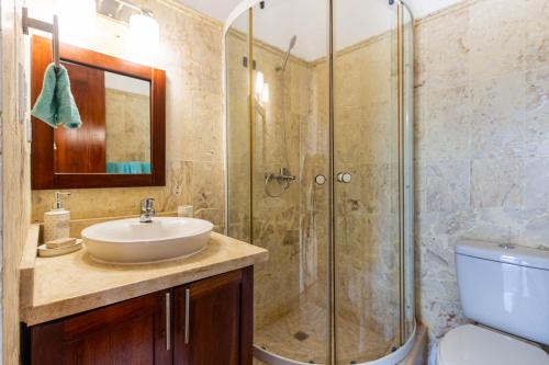a bathroom with a sink and a shower at Novus Mare, Cabarete center! in Cabarete