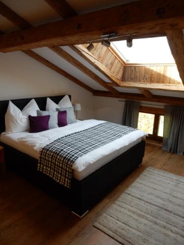 a bedroom with a large bed with purple pillows at Häuserhof in Stumm
