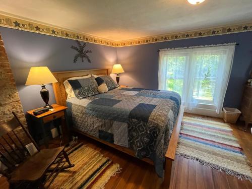 a bedroom with a bed and a window at Rainbow Ridge Farms in Onalaska