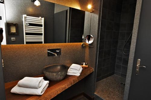 a bathroom with a sink and a mirror at Logis Hôtel - Auberge les Clarines in Le Châtelard