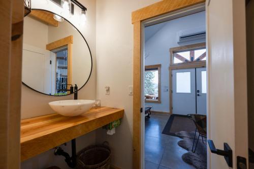a bathroom with a sink and a mirror at Anasazi Cliffs Lodging in Apple Valley