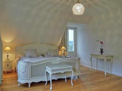a bedroom with a white bed and two tables at Rheinvilla Weitblick in Boppard