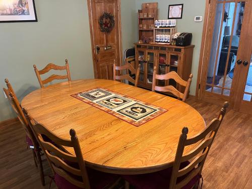 a wooden table and chairs in a room at Rainbow Ridge Farms in Onalaska