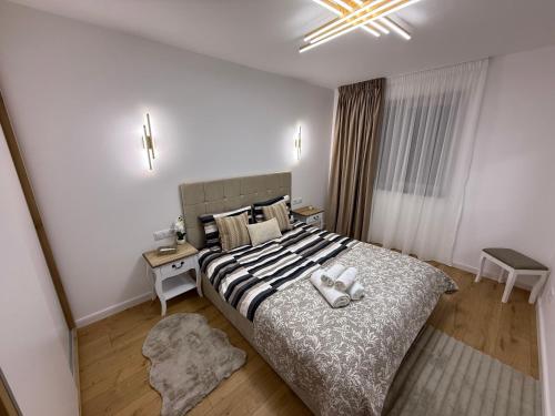 a bedroom with a bed with two towels on it at Luxury Residence in Baia Mare