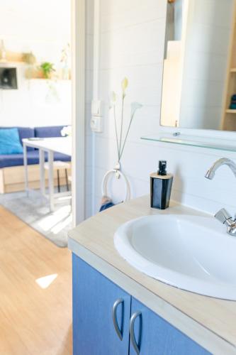 a bathroom with a white sink and a mirror at Louisiana in Anloo