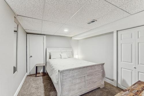 a bedroom with a bed and a white ceiling at Group-Friendly Michigan City Home Near Beach! in Michigan City