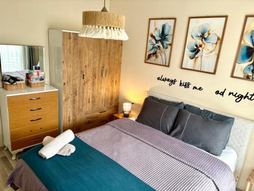 a bedroom with a bed with a blue comforter at Theos Holiday Apartments Room 23 Family Suit Accommodation For Families Only in Kuşadası