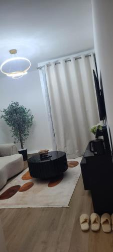 a living room with a couch and a table at Lace Luxe Homes in Tatu City