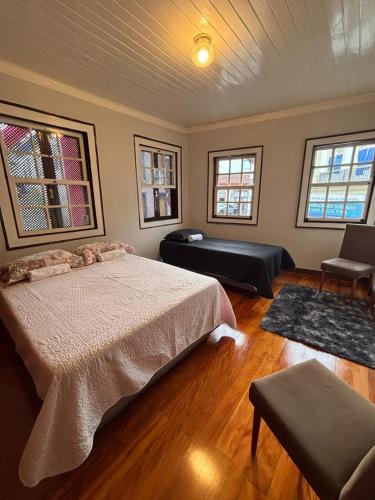 a bedroom with a bed and a living room at Sollarium Pousada in Diamantina
