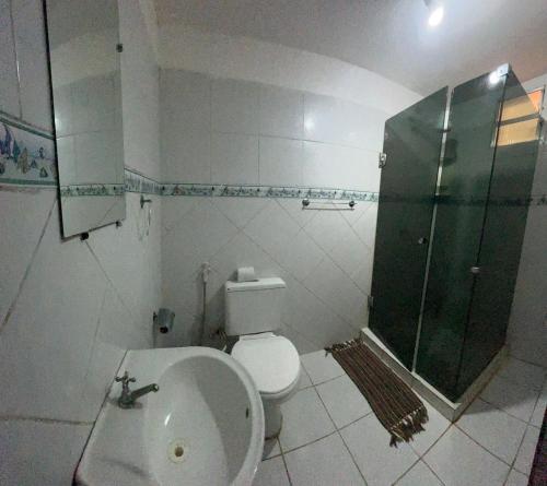 a bathroom with a shower and a toilet and a sink at Recanto do caja in Porto De Galinhas