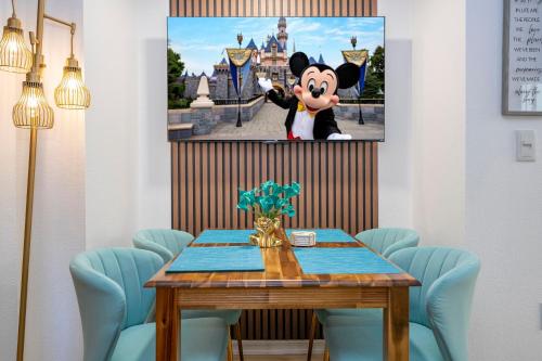 a dining room with a mickey mouse painting on the wall at Unique stay 6 min from Universal Free parking in Orlando