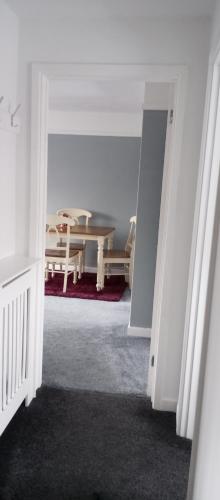a hallway with a table and a dining room at Lilypad in Devizes