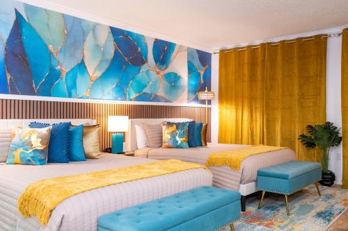 a bedroom with two beds and a painting on the wall at Unique stay 6 min from Universal Free parking in Orlando