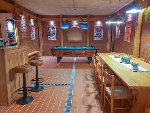 a billiard room with a pool table and a bar at Apartment Feher Lendava in Lendava
