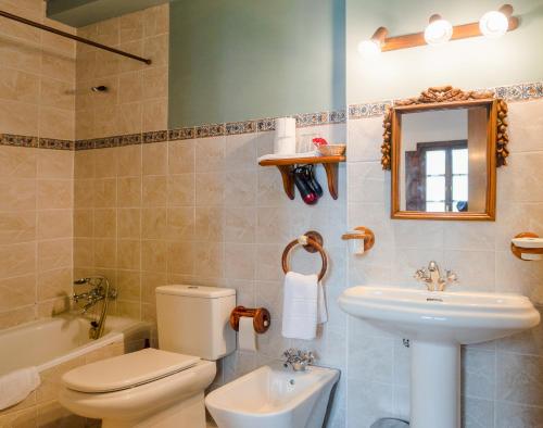 a bathroom with a toilet and a sink and a mirror at Bisabuela Martina in Liendo