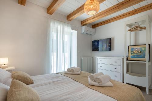 a bedroom with a large bed with towels on it at Villa Gino in Pazin