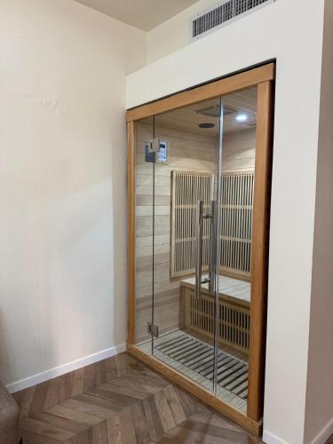 a walk in shower in a room with a glass door at חדר על הים בבת ים in Bat Yam