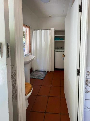 a bathroom with a toilet and a sink at Ruby Bay Beach Sleepout - 30 mins from Abel Tasman in Mapua