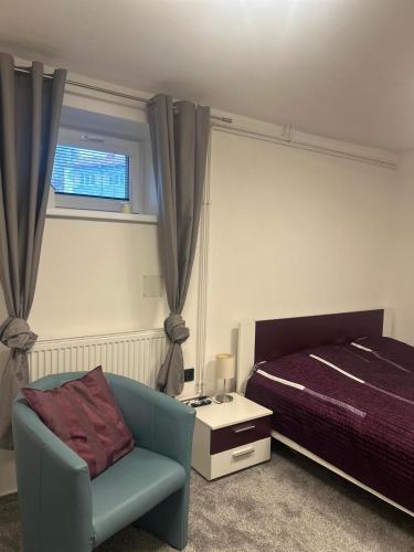 a bedroom with a bed and a chair and a window at Byt v podzámčí in Litomyšl