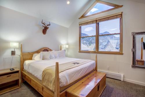 a bedroom with a large bed and a window at Jackpine & Black Bear Condos by Vail Resorts in Keystone