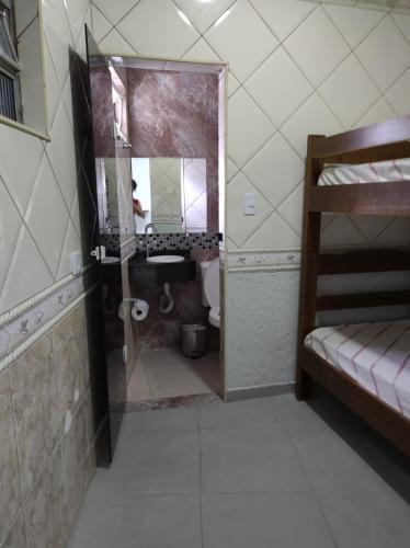 a bathroom with a sink and a toilet and a mirror at Hotel Flor da Vila Mariana in São Paulo