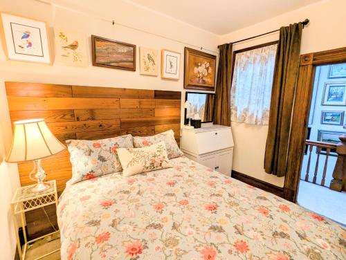 a bedroom with a bed and a lamp and a window at Perfect Location - 4BD,1BA - Restored Redwood Home in San Francisco