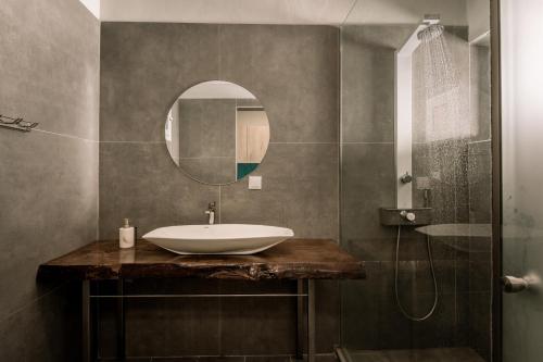 a bathroom with a sink and a mirror at Bay View Suites & Apartments in Marathias