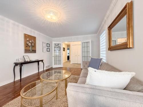 a living room with a couch and a table at The Promenade Cottage License # 002-2023 in Niagara on the Lake