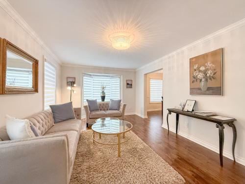 a living room with a couch and a table at The Promenade Cottage License # 002-2023 in Niagara-on-the-Lake
