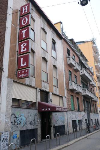 a building with a hotel sign on the side of it at Hotel Lugano in Milan