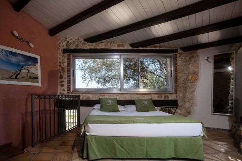 a bedroom with a bed in a room with a window at Villa Roba degli Ulivi in Agrigento
