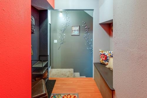 a room with a red wall and a stairway at 2 Mi to Dtwn Cozy Getaway in Fairbanks! in Fairbanks