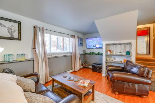 a living room with leather furniture and a table at 2 Mi to Dtwn Cozy Getaway in Fairbanks! in Fairbanks