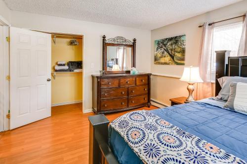 a bedroom with a bed and a dresser and a mirror at 2 Mi to Dtwn Cozy Getaway in Fairbanks! in Fairbanks