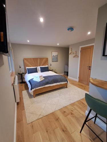 a bedroom with a large bed and a wooden floor at An Sealladh in Fort William